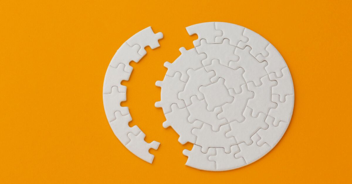 A set of puzzle pieces set away from a puzzle