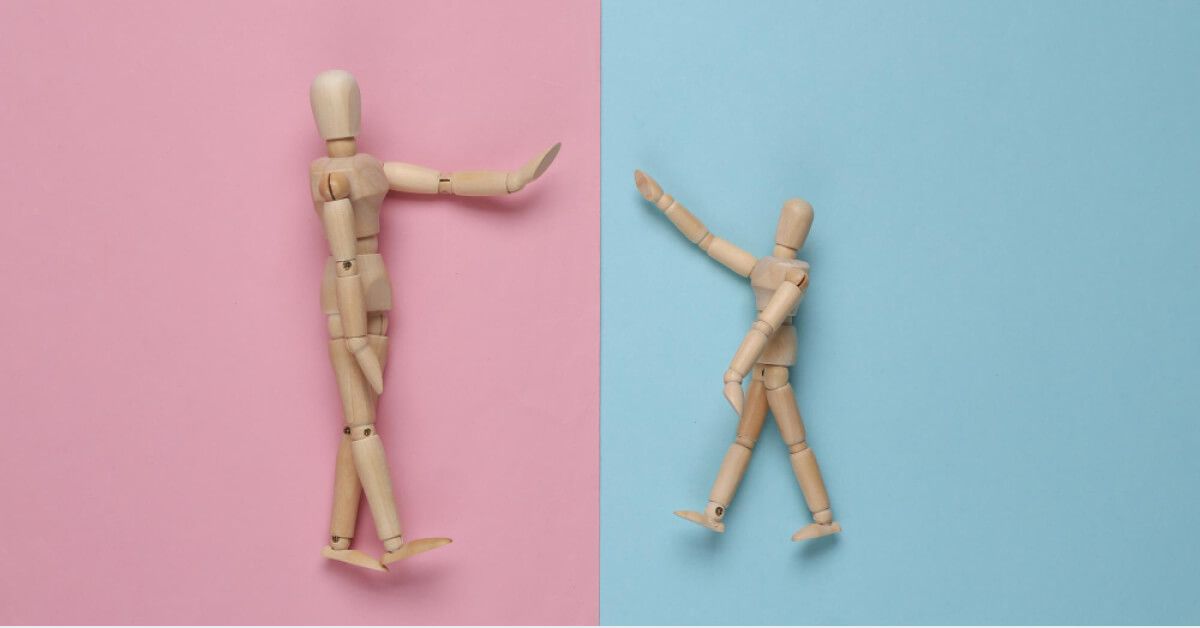 Wooden dolls against coloured backdrops