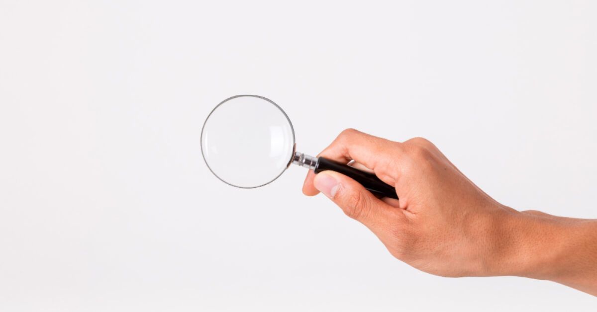 Person holding a magnifier glass