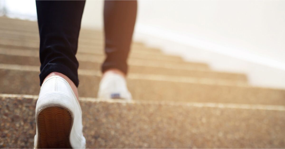 Person walking up a set of stairs