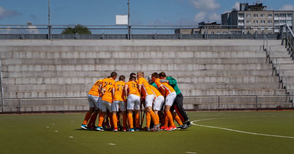 A hockey team participating in a group huddle