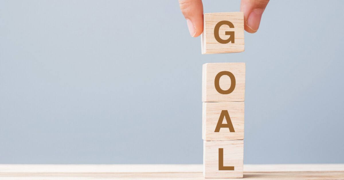 A tower of blocks with letters that form the word "GOAL"