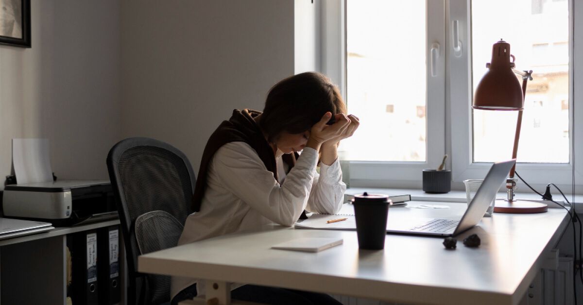 A sad female employee in the workplace