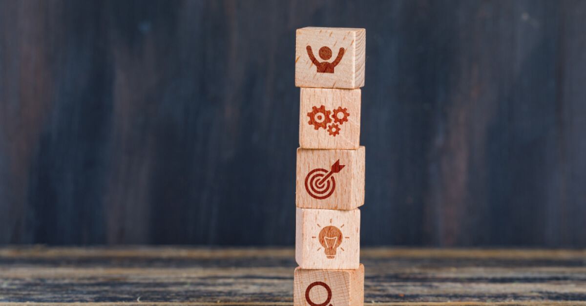 Wooden blocks with engraved icons, placed on top of each other