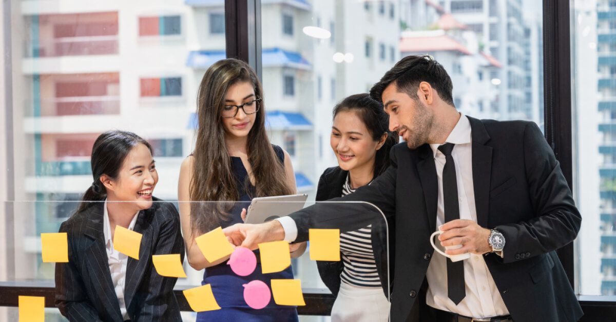 A group of employees reacting at notes together