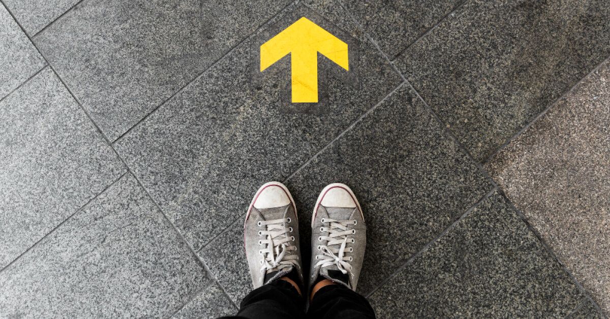 An yellow arrow in front of a person