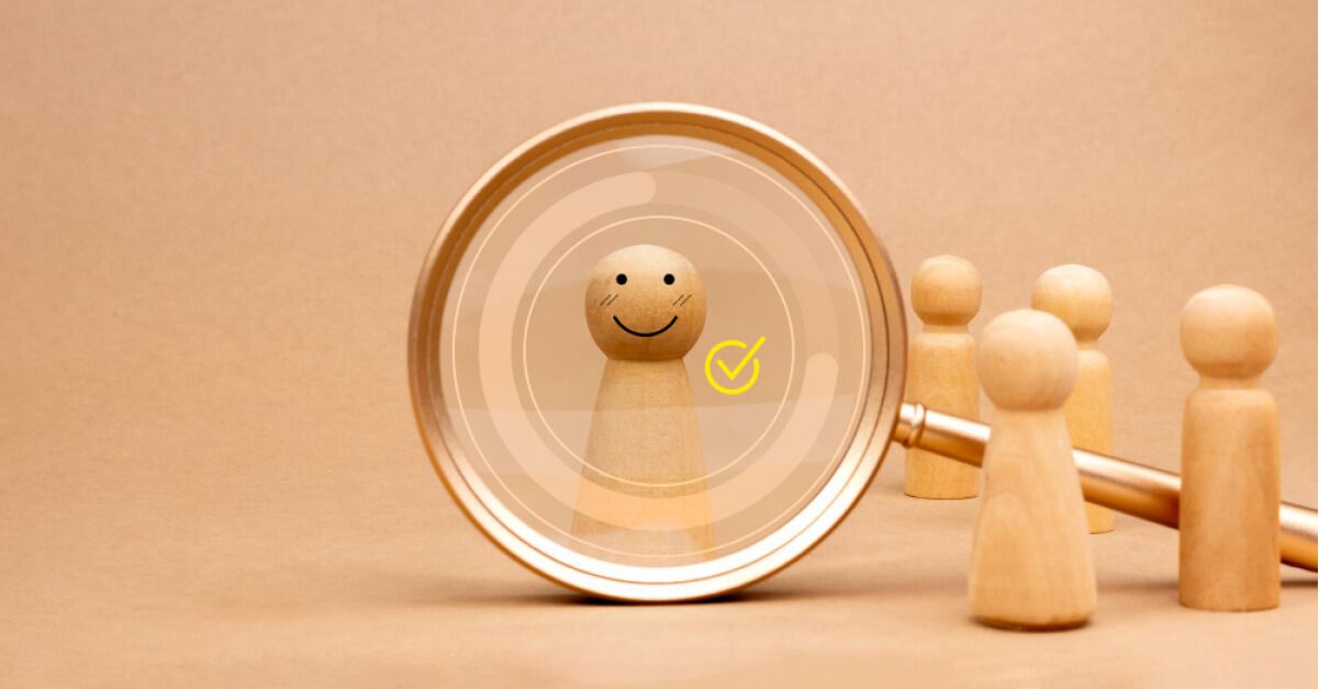 Magnifier glass over a wooden pawn with vector tick emoji