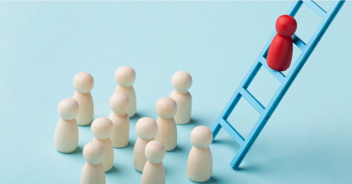 Red pawn on top of a ladder amidst other white pawns