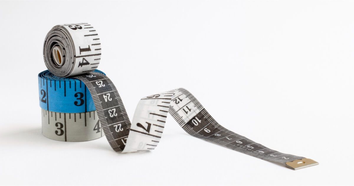 A stack of blue and white measuring tapes