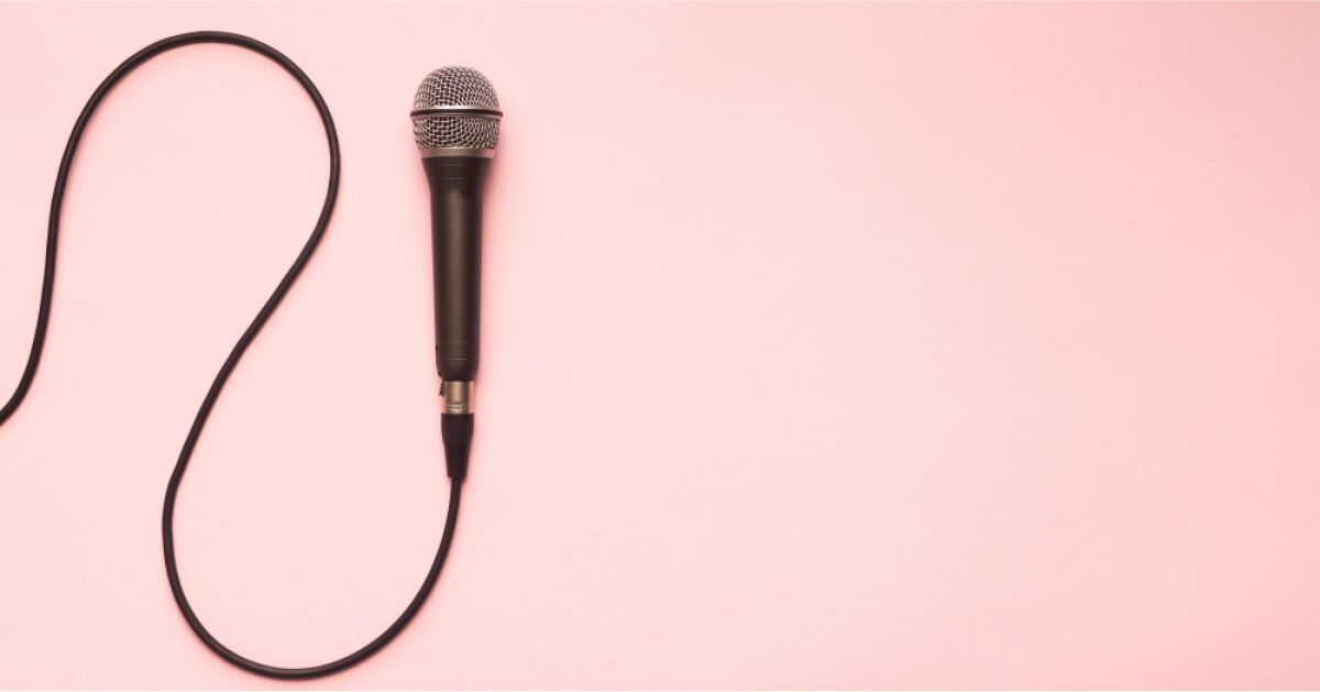 Mic with cord, against a pink backdrop