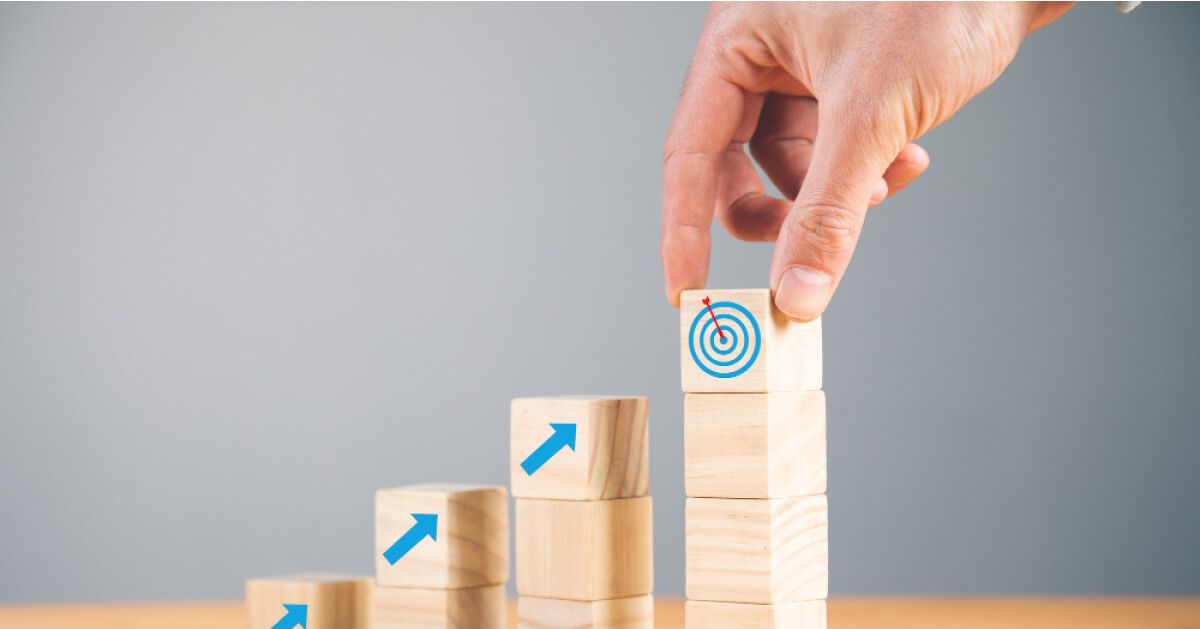 Towers of wooden blocks with arrow and target graphics