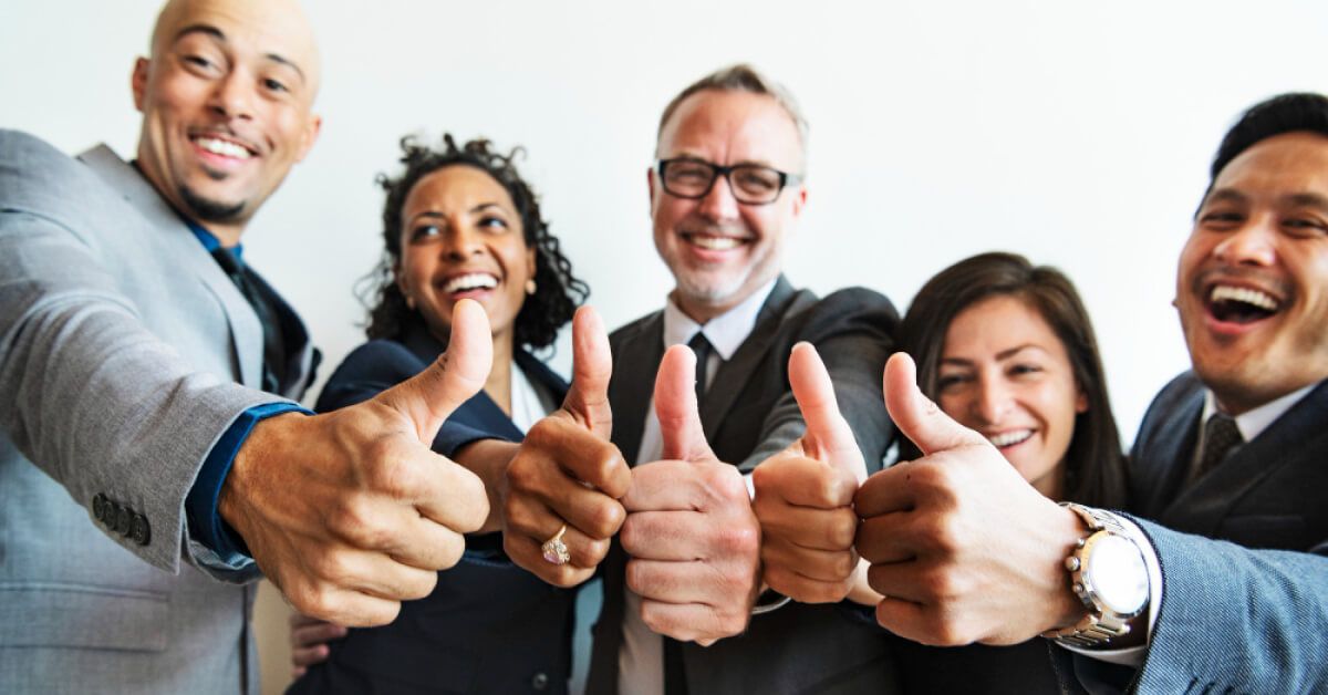 Group of employees showing thumbs up reactions