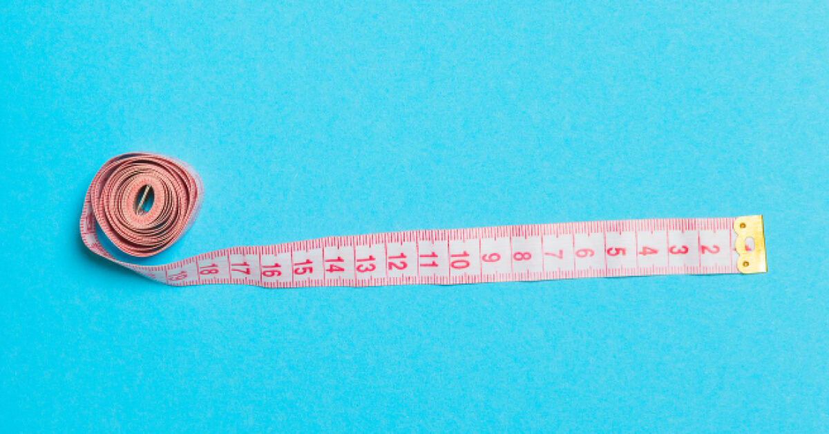 Measuring tape against a blue backdrop