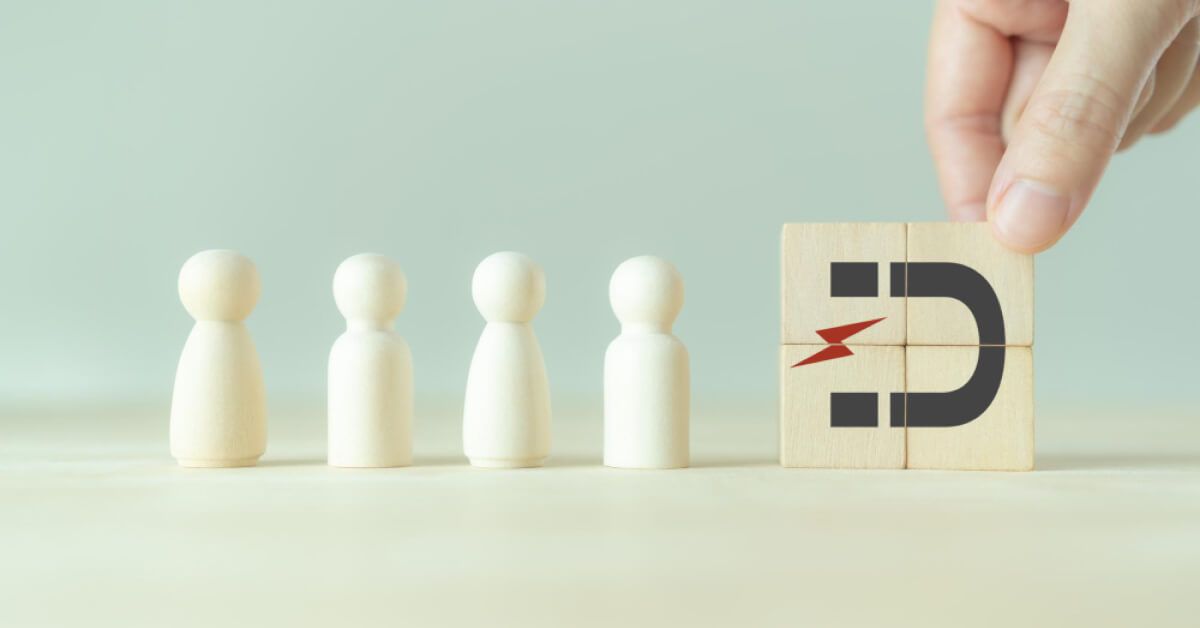 Wooden blocks forming a magnet visual, pointed at a series of pawns