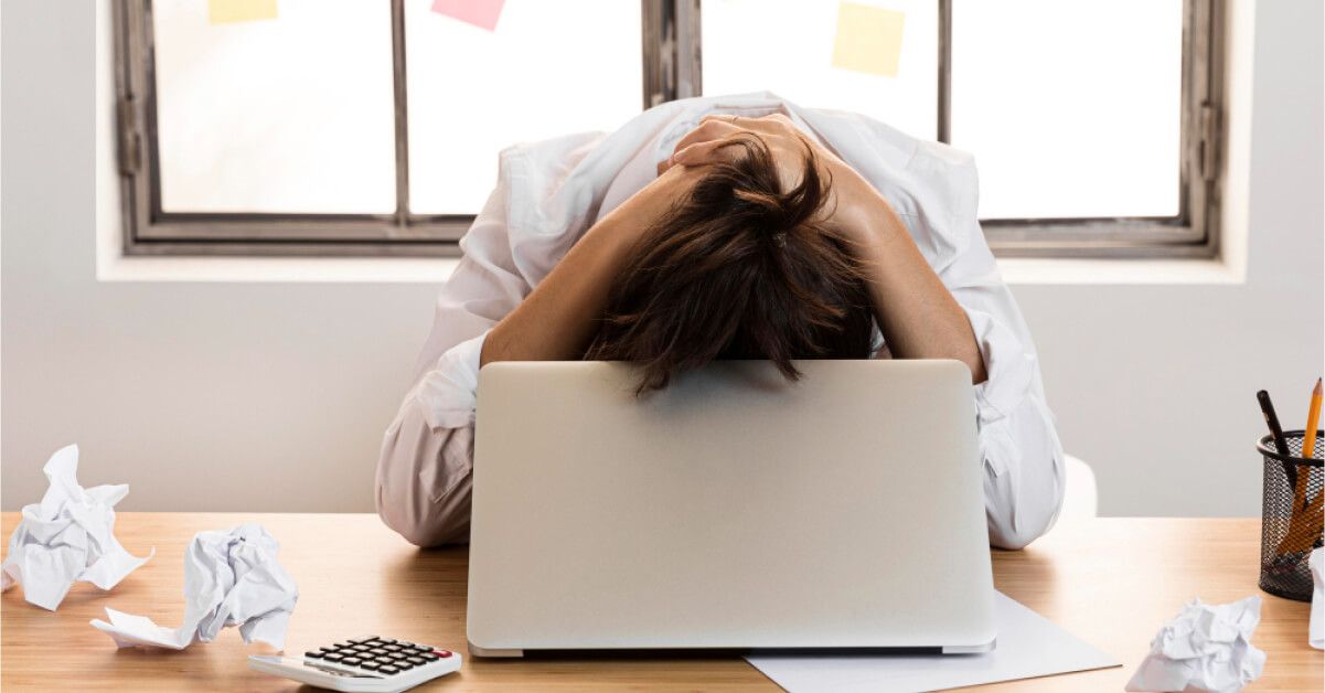 Disgruntled employee in front of a laptop