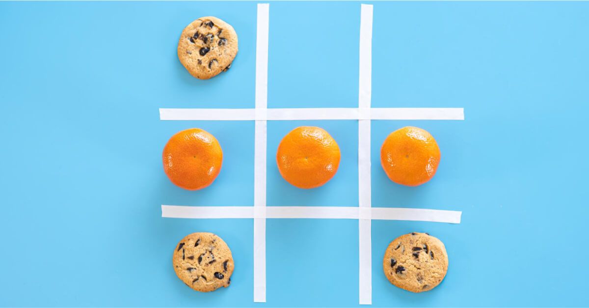 A tic tac toe with cookies and oranges 