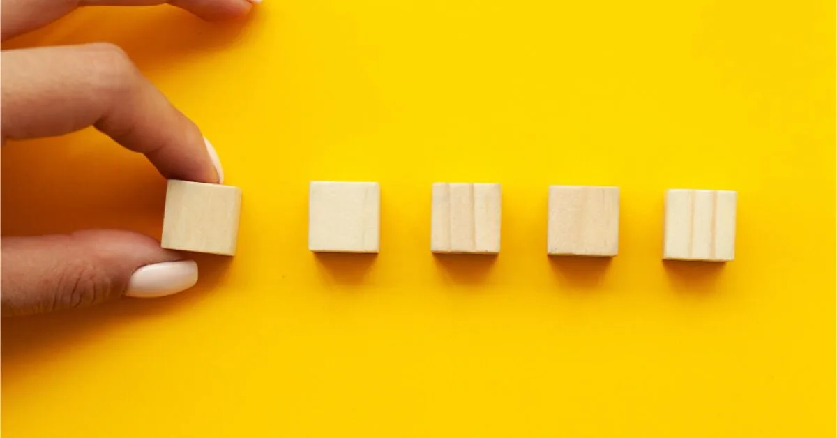 Wooden cubes in a yellow background